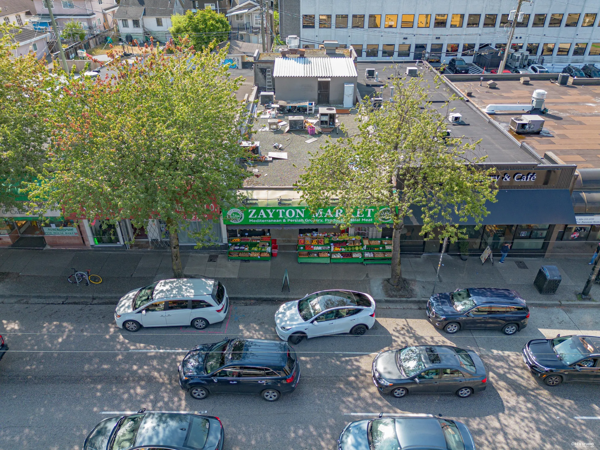 Aerial view along Hastings with the green Zayton Market sign visible below