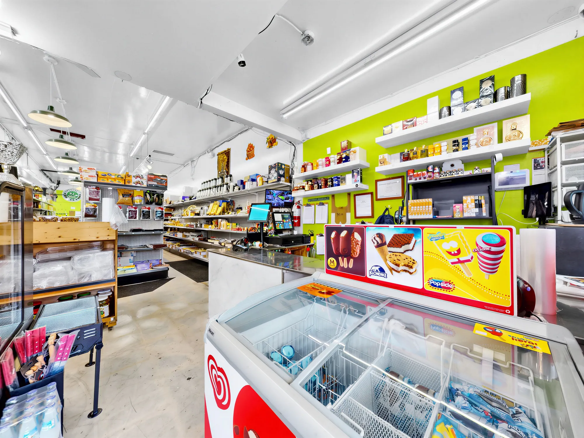 Counter area with ice cream freezer and the wall of shelving behind