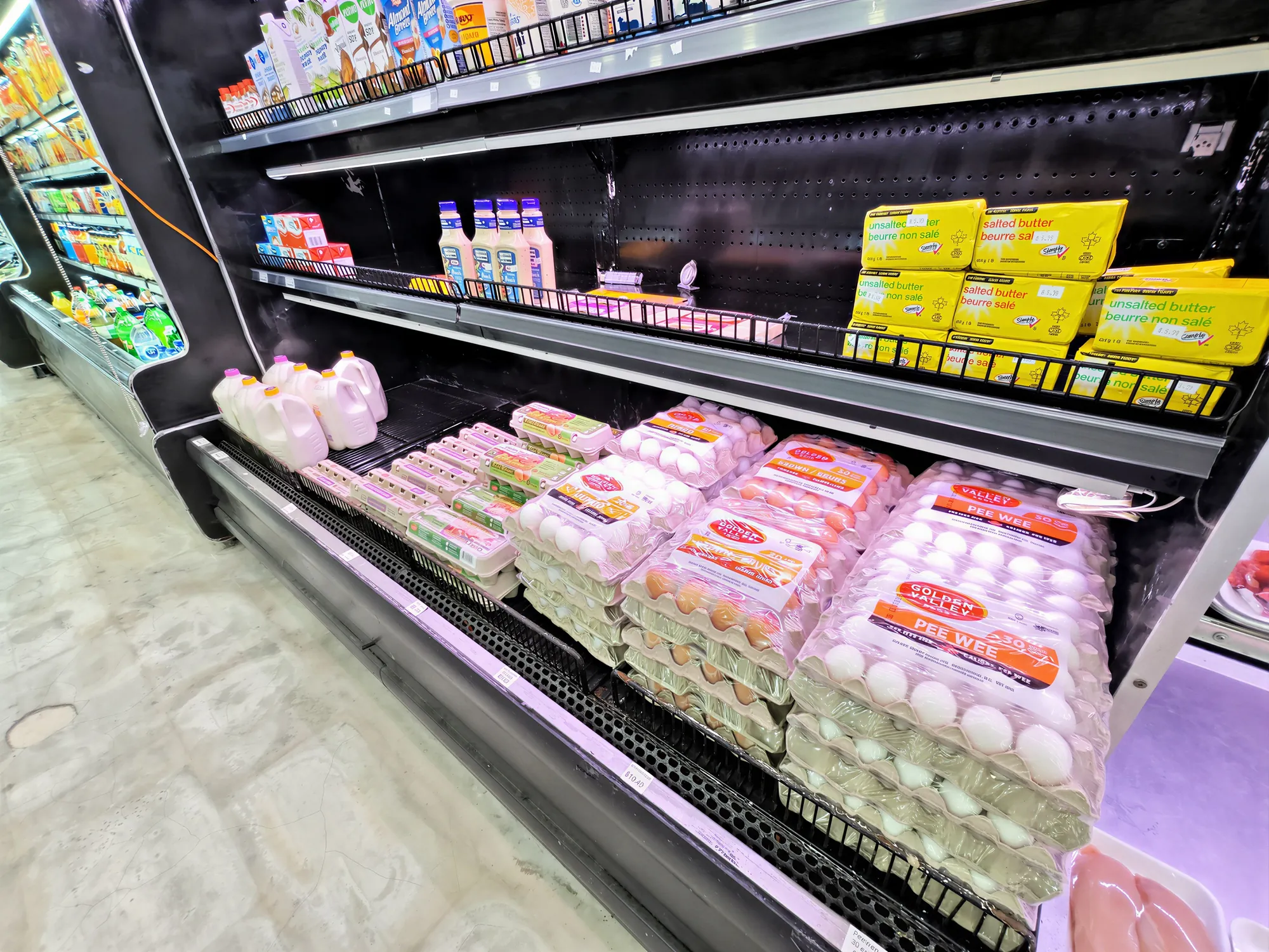Close view of the stocked dairy and egg shelves