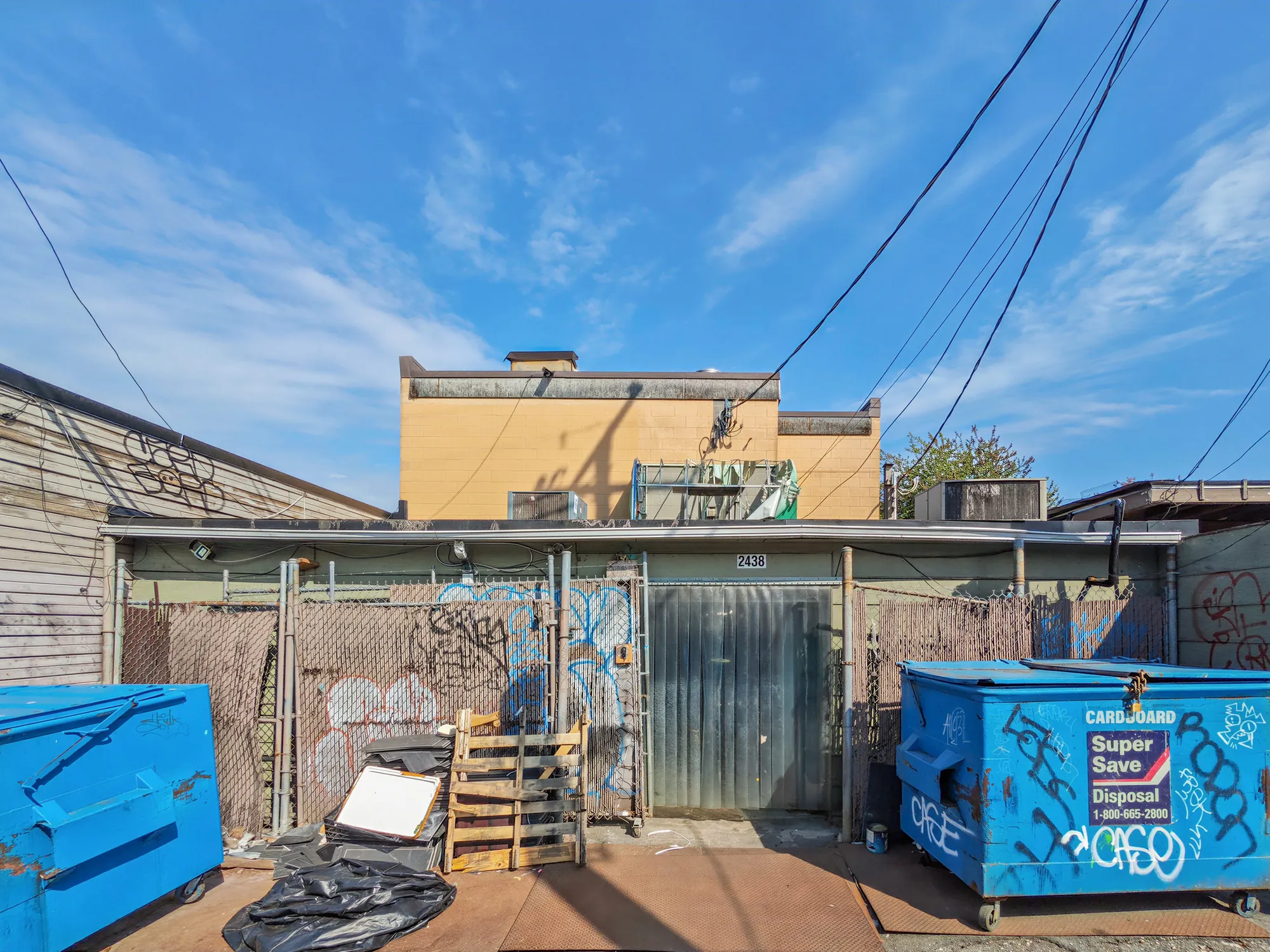 The rear lane with loading area and bins behind the building