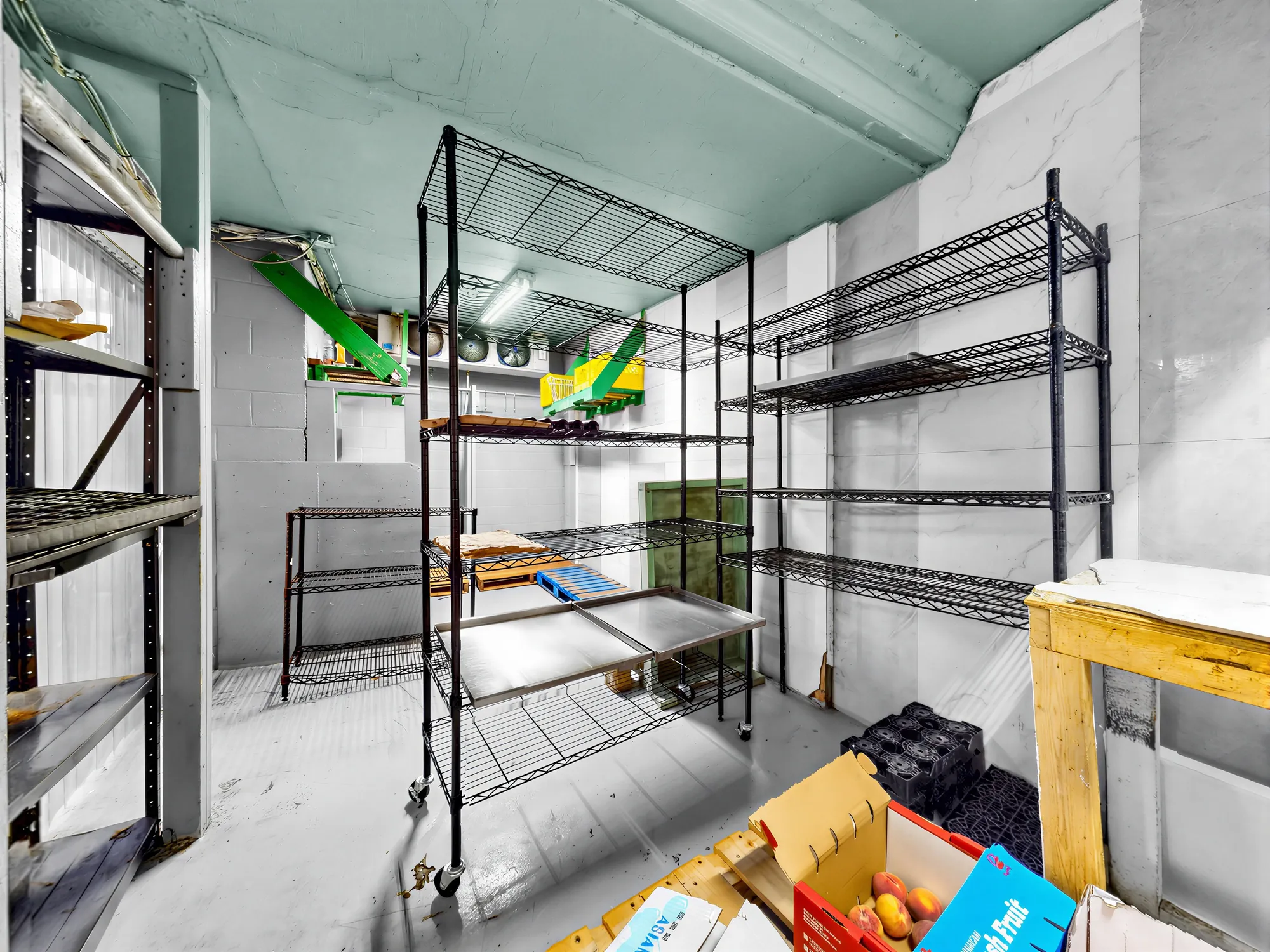 Storage room with wire shelving and stacked crates