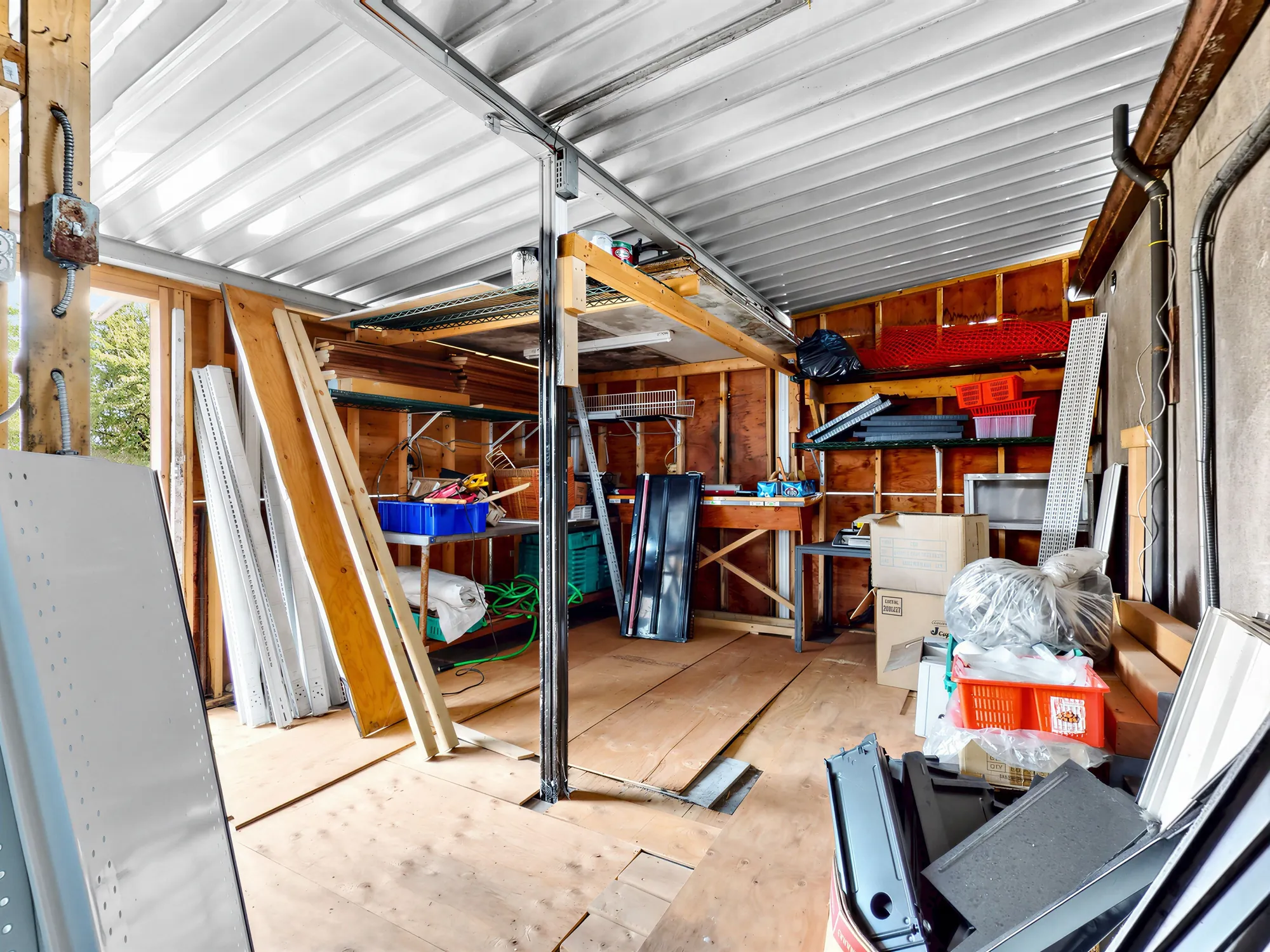 The unfinished upper level: bare joists, timber framing and stacked building materials
