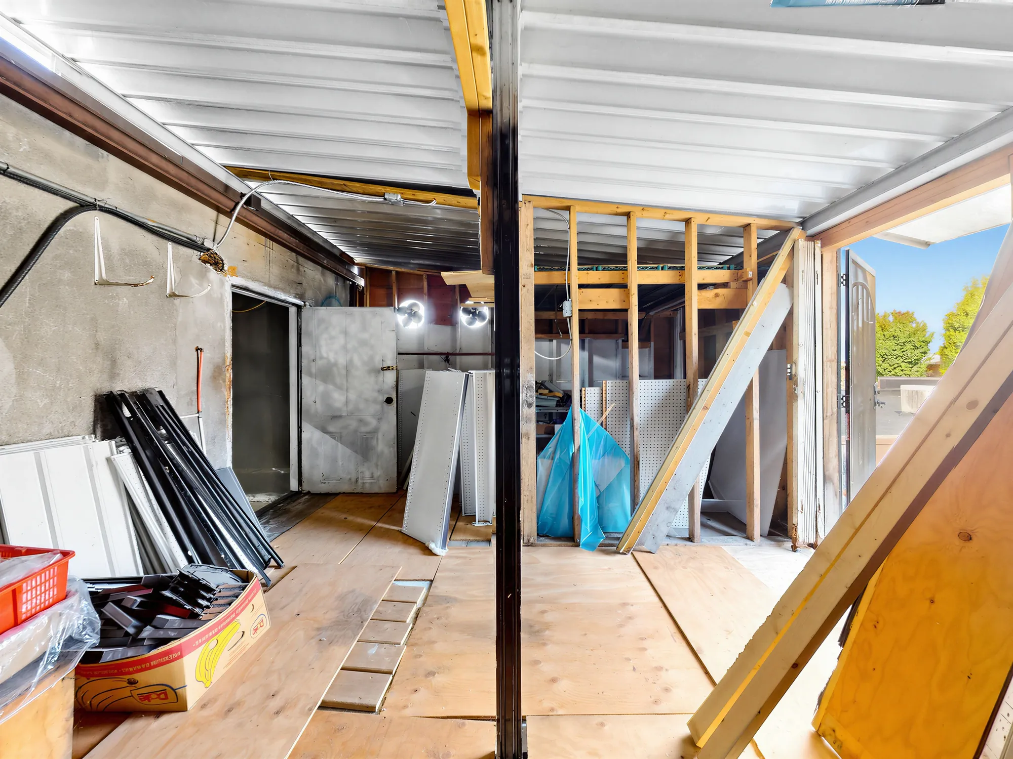Upper level with a cold room door, stud framing and stacked panels