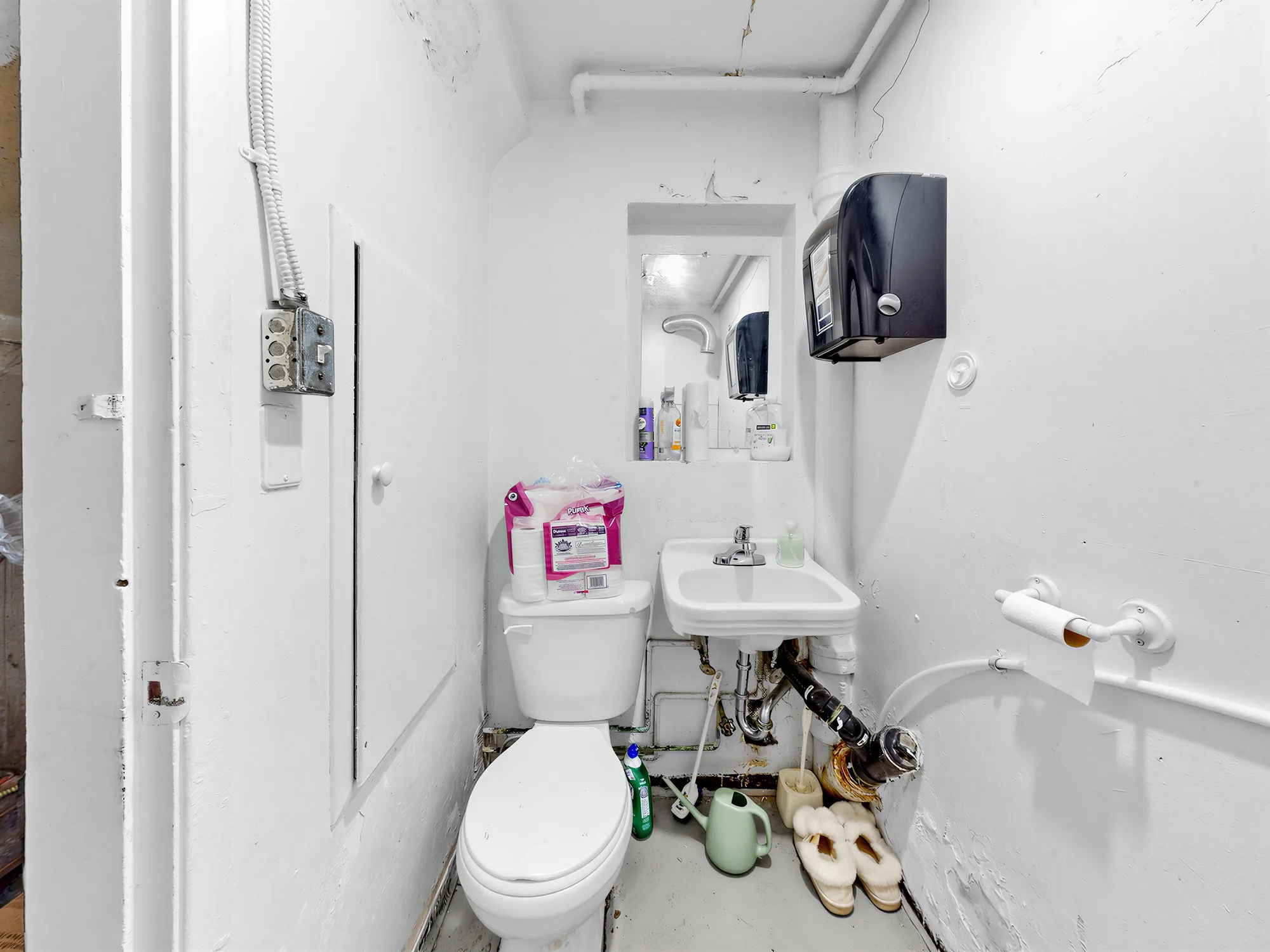 Staff washroom with basin and toilet